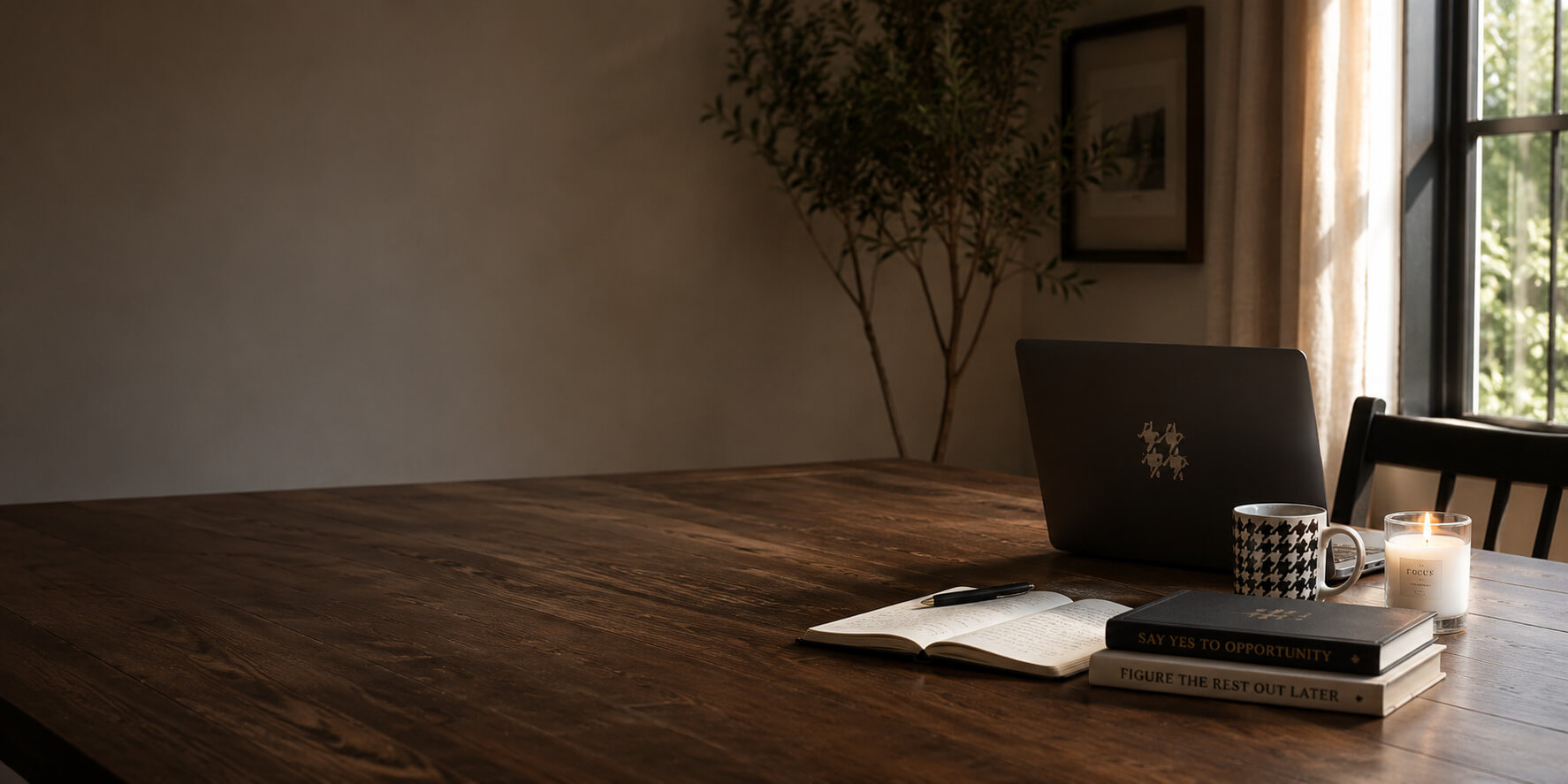 Wooden desk with a laptop, notebook, coffee mug, and office supplies in a quiet workspace.